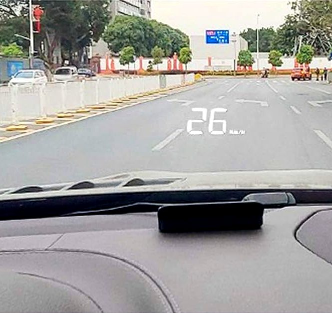 A Marelle M1 on the dashboard, projecting road speed onto the windshield